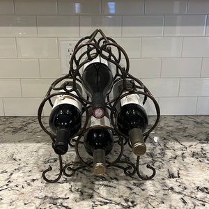 Wrought iron wine holder. Height:13 inches, width:11 inches,weight approx. 4 lbs